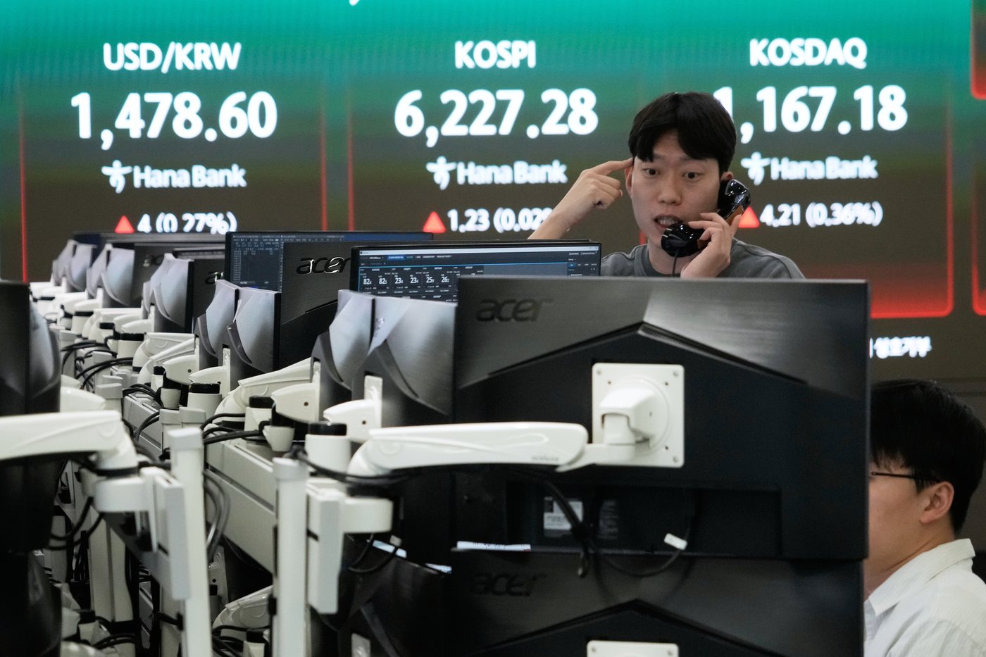 Asian stocks lower and oil falls after Wall Street sets another record ...
