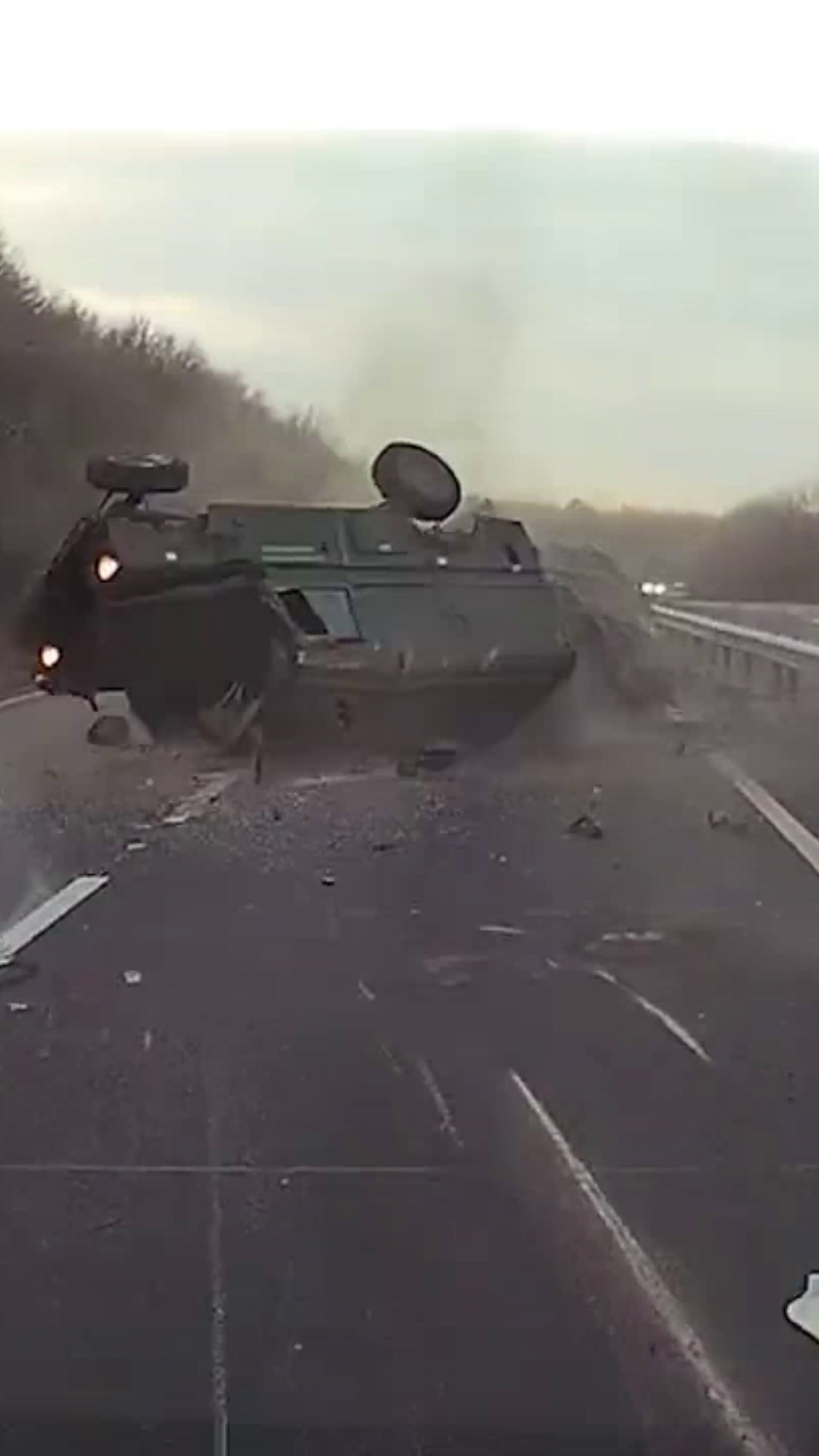 Driver flung from army truck after car swerves in front of military convoy