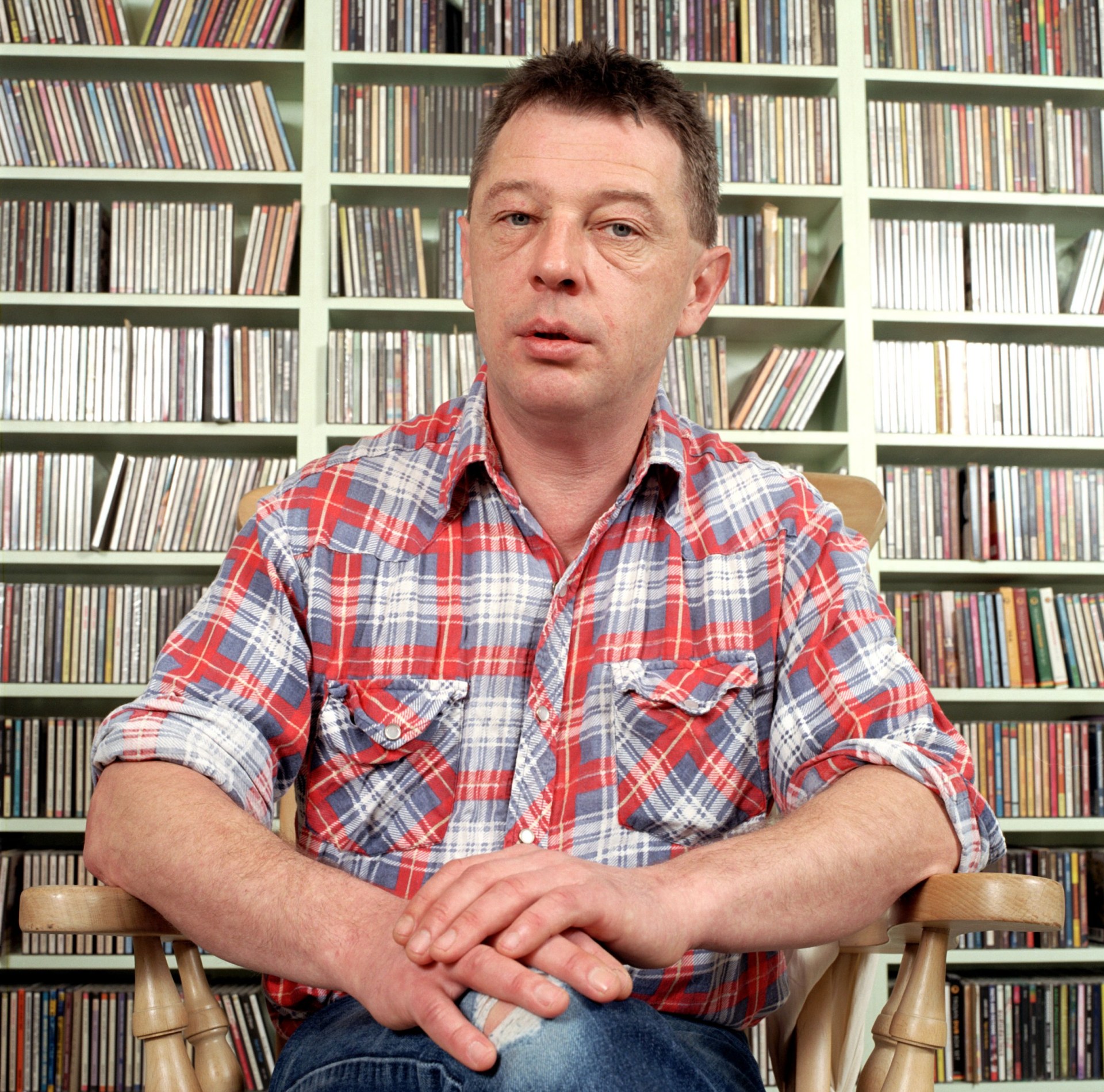 Portrait of music broadcaster Andy Kershaw photographed at home in London in January 2005