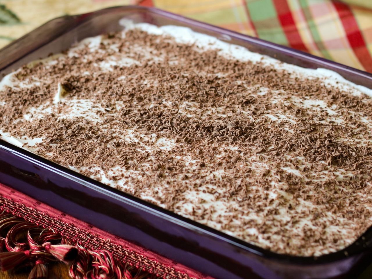 close up view of a Vanilla and Chocolate Delight dessert, garnished with shaved chocolate, in a baking dish