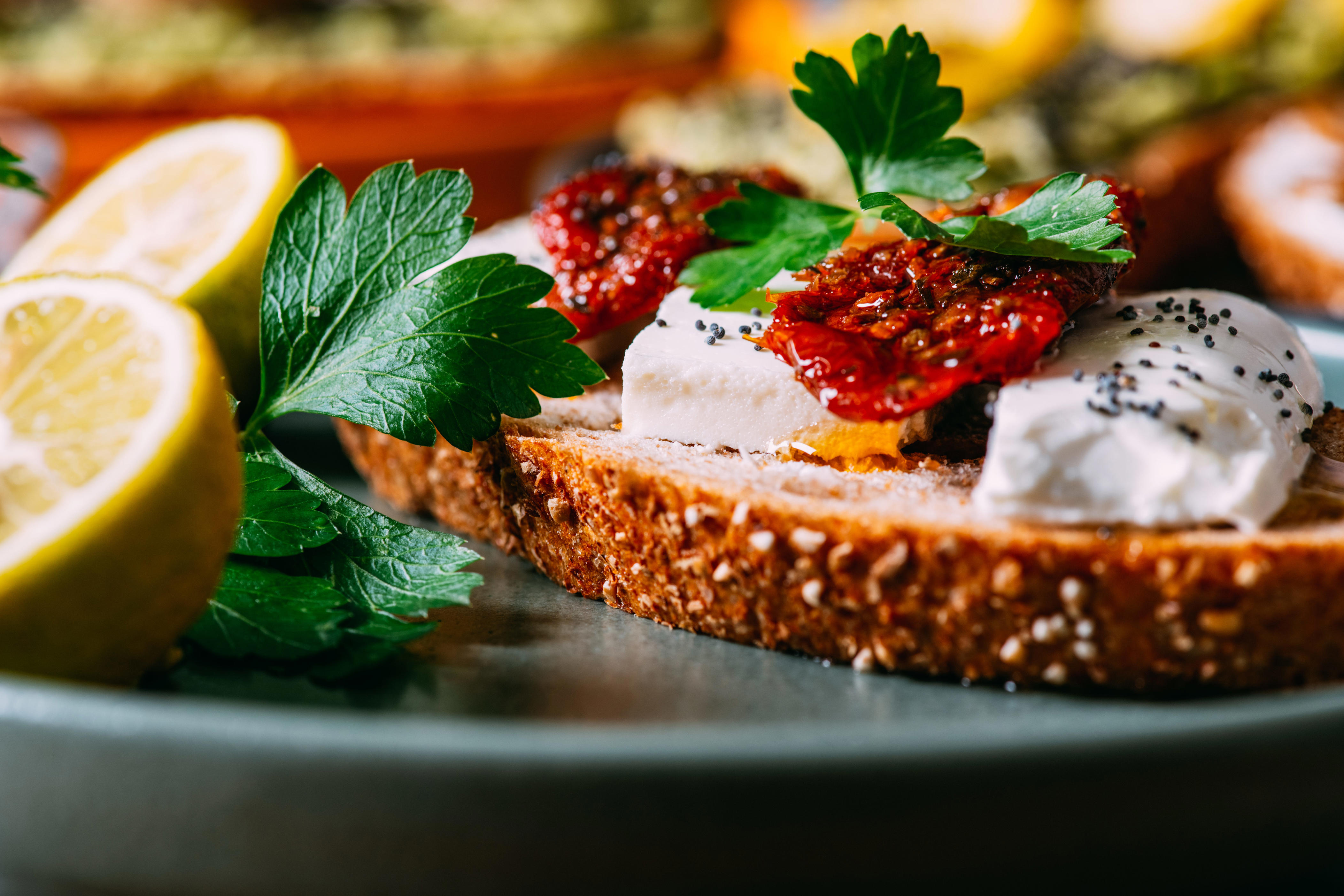 A slice of bread with tomato and feta on top.