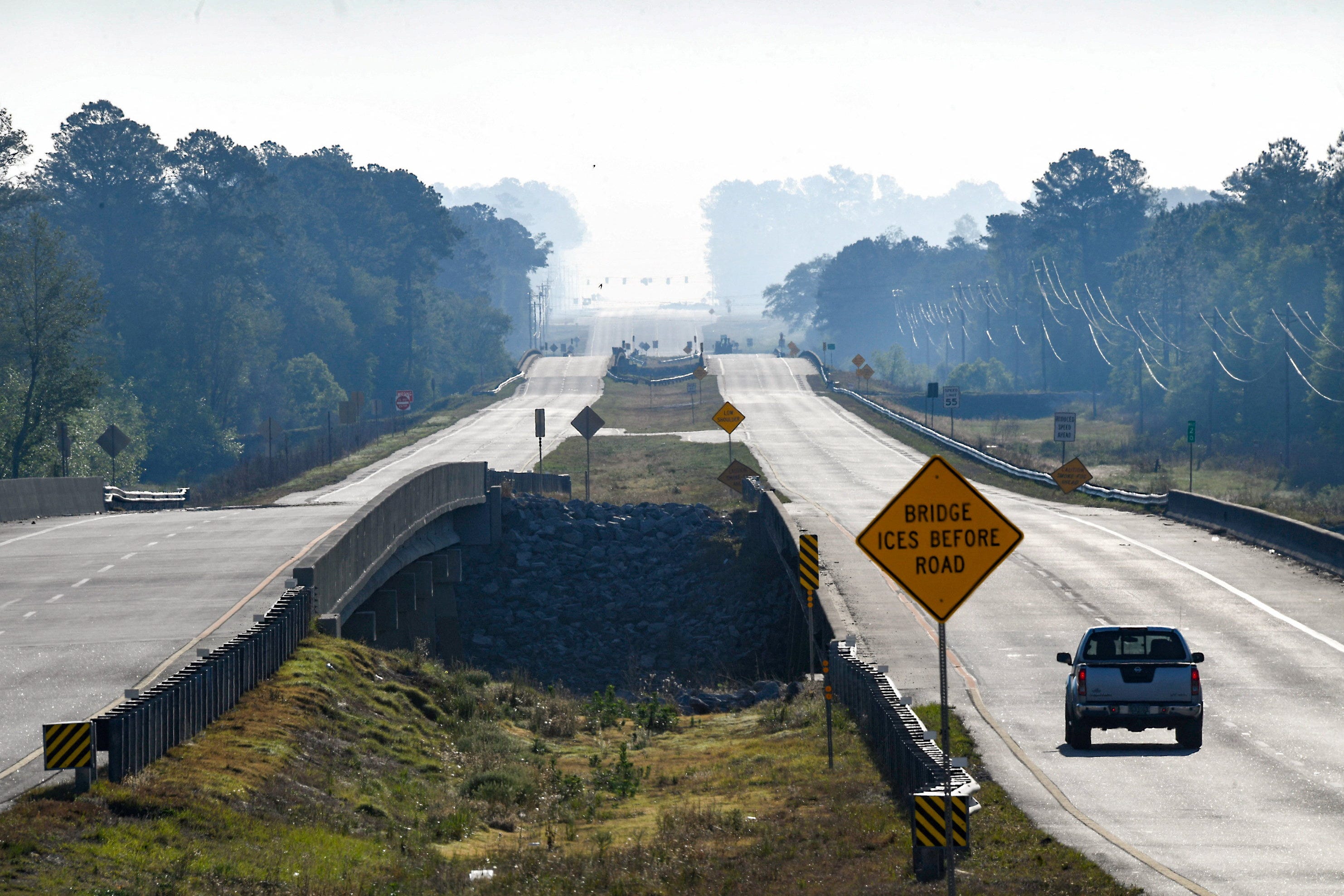 Smoke rises over U.S. Route 82, as a wildfire continues to burn across Brantley County, in Lulaton, Georgia, pictured on April 23, 2026.