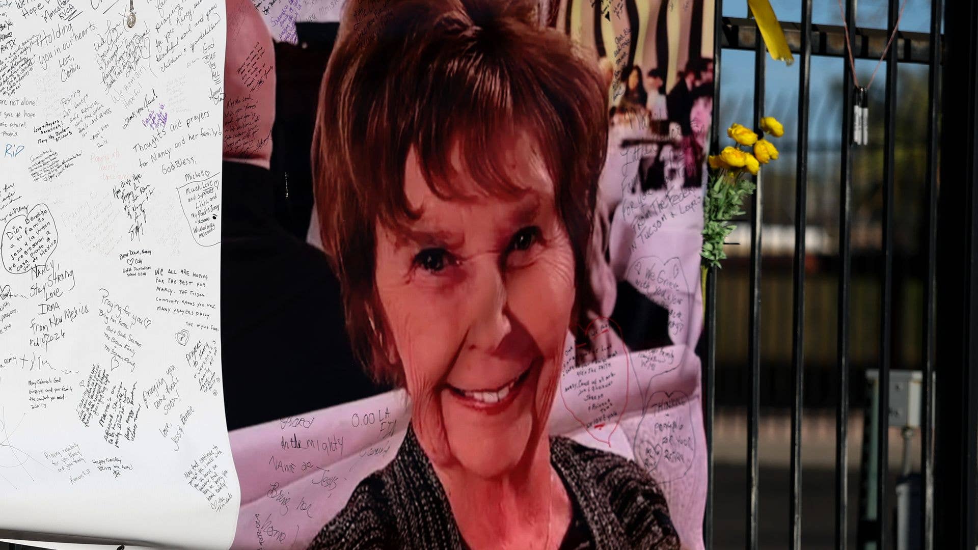 TUCSON, ARIZONA - FEBRUARY 26: A photograph of Nancy Guthrie is seen on a sign that people can leave messages on February 26, 2026, in Tucson, Arizona. Law enforcement officials continue to search for Nancy Guthrie, the 84-year-old mother of U.S. journalist and television host Savannah Guthrie, after she went missing from her home on the morning of February 1st. (Photo by Joe Raedle/Getty Images)