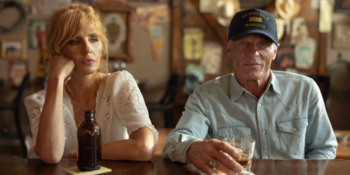 Beth Dutton (Kelly Reilly) and Everett McKinney (Ed Harris) sit at a bar in Dutton Ranch