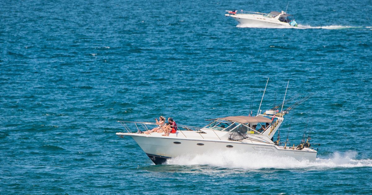 Closeup of two boats sailing across Portage Lake near Onekama, Michigan