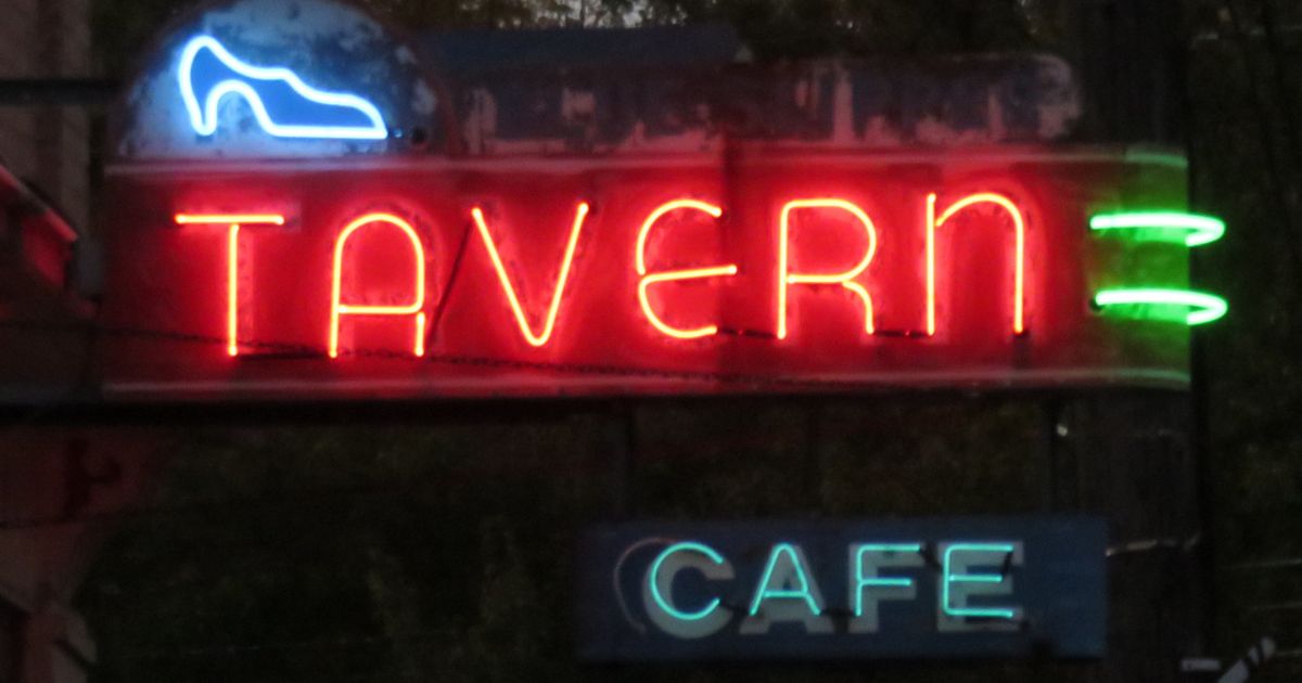 Neon sign for the Blue Slipper Tavern in Onekama, Michigan, at night
