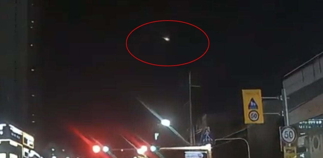Fiery elliptical object falls from night sky as fireball