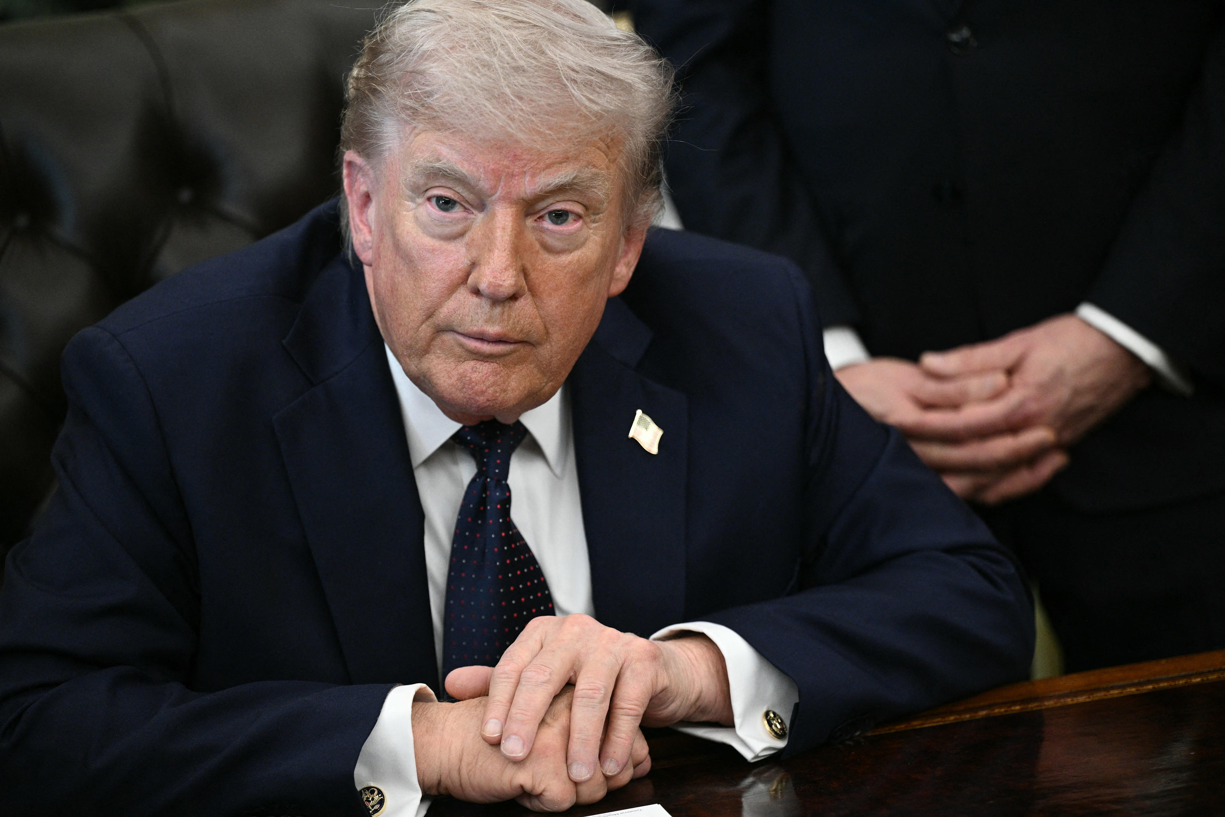 US President Donald Trump looks on during a meeting with Lebanon's Ambassador to the US, Nada Hamadeh Moawad, and Israel's Ambassador to the US, Yechiel Leiter, at the White House in Washington, DC on April 23, 2026. US President Donald Trump met Lebanese and Israeli envoys at a new round of peace talks Thursday, with Beirut seeking a one-month extension of a shaky ceasefire set to expire.