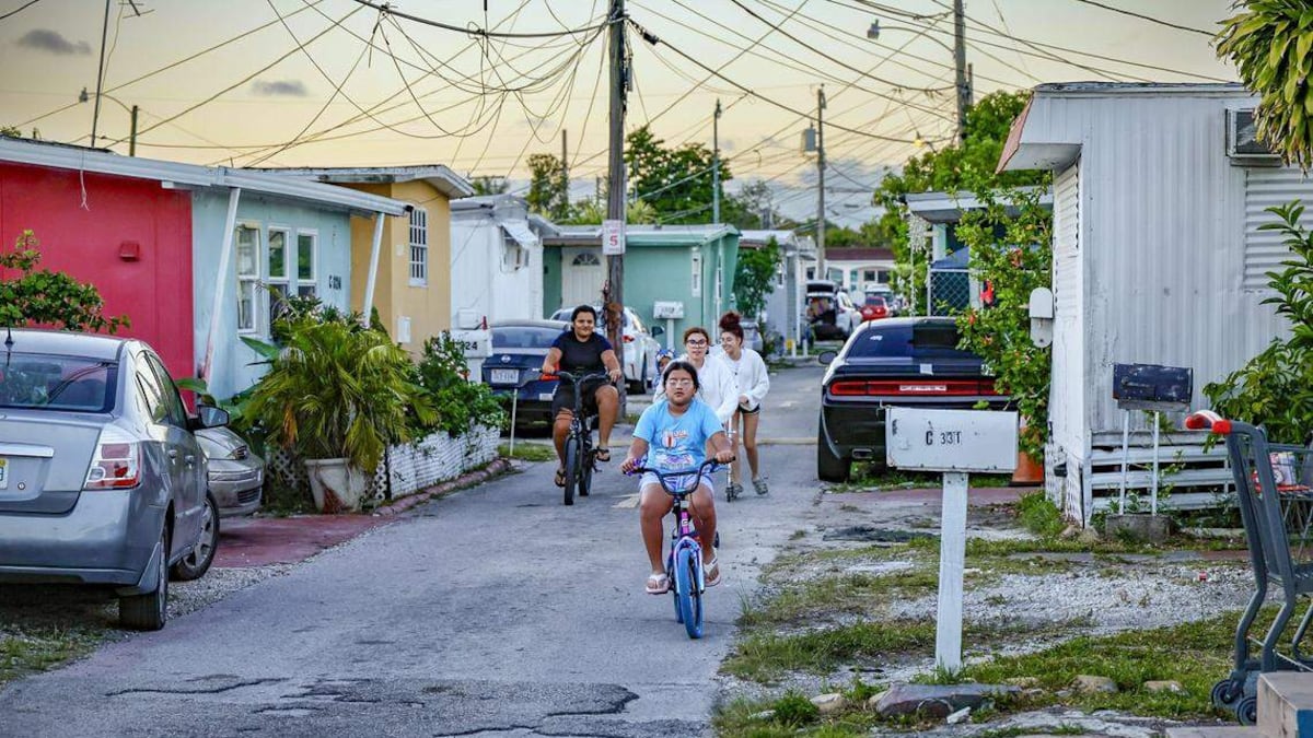 Children ride through Silver Court Mobile Home Park located at 3170 SW 8th Street in Miami on April 17. The trailer park is closing as 200 families will soon be evicted to make room for development. ©PHOTO BY AL DIAZ