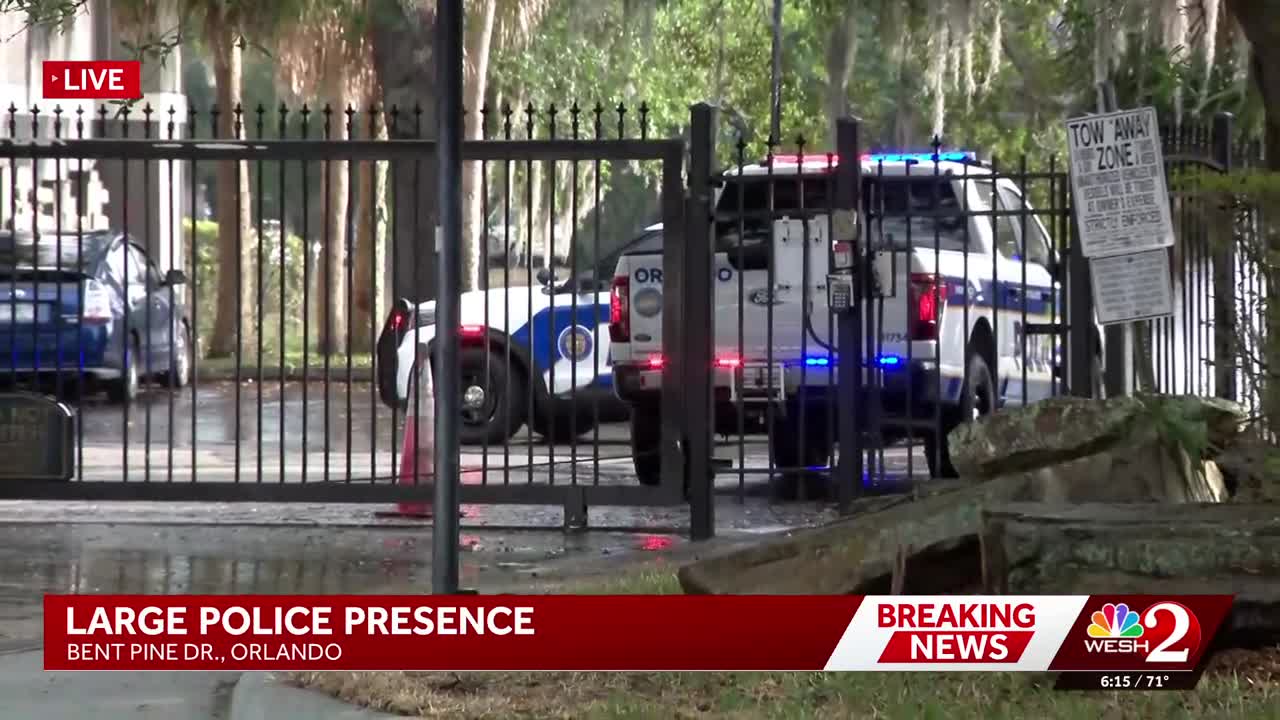 Large police presence surrounding gated apartment complex in Orlando