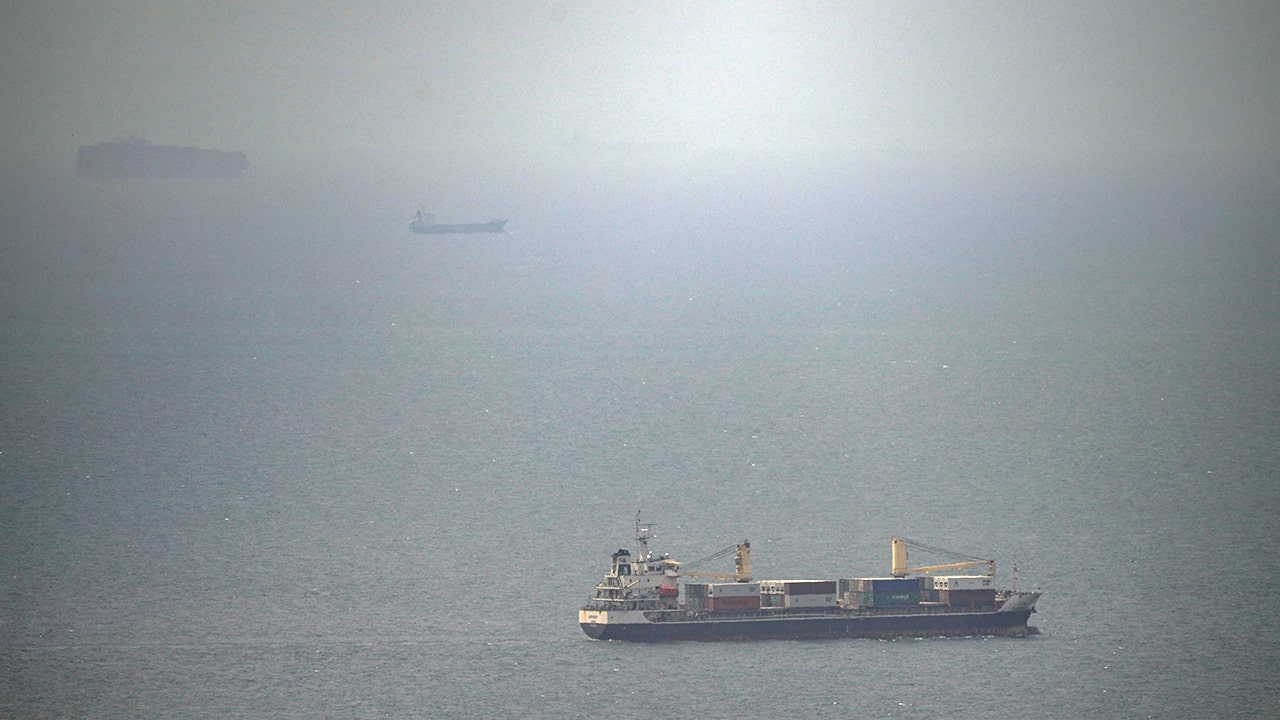 A cargo ship sailing in the Persian Gulf toward the Strait of Hormuz