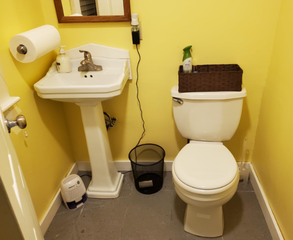 Dehumidifier on the floor of a bathroom