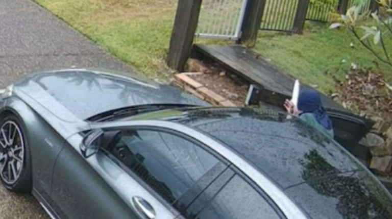 CCTV shows a hooded thief with a large knife getting out of the blue Mustang and trying to start an unlocked car in the driveway of a home on the Gold Coast yesterday morning.