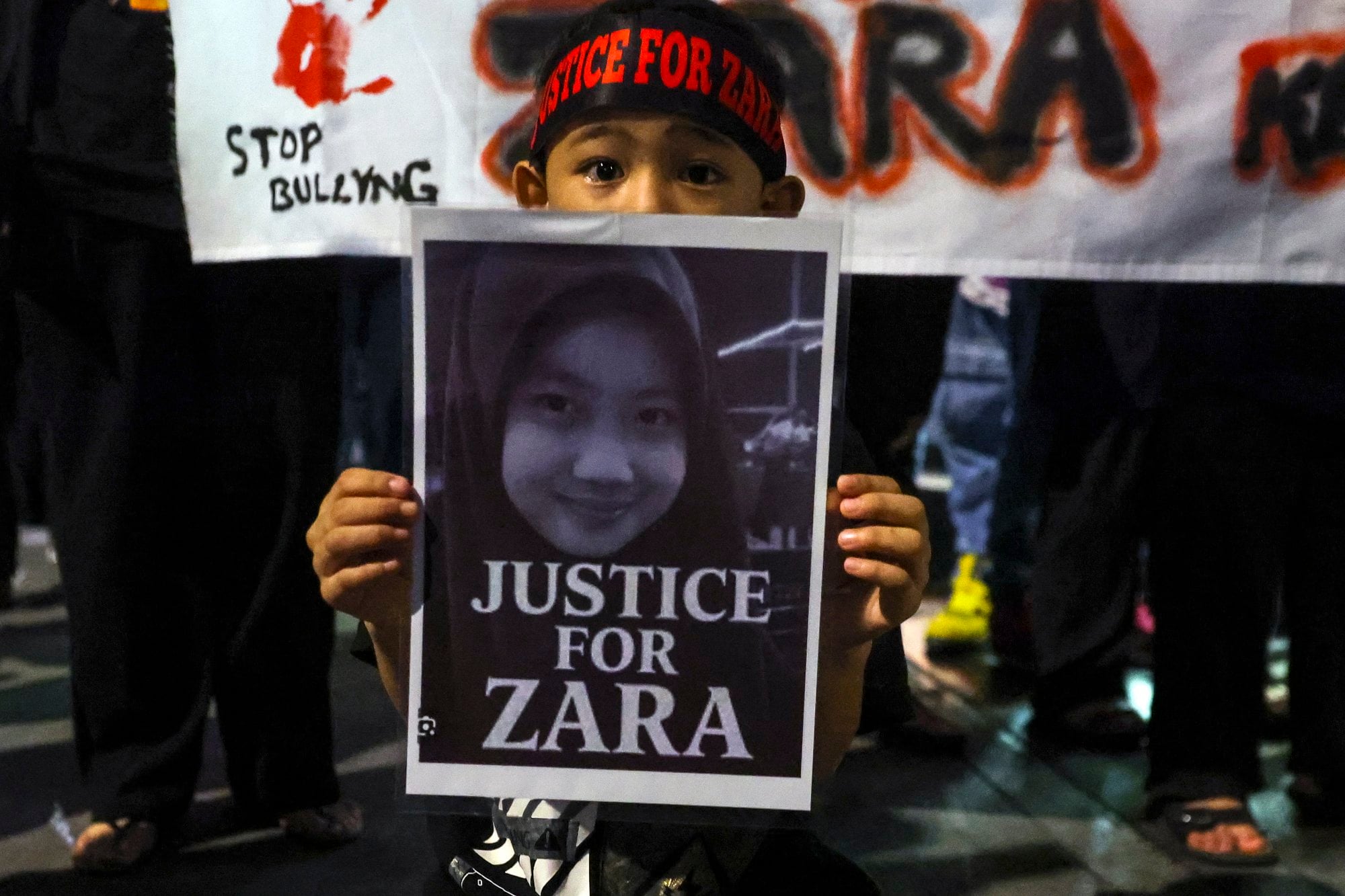 A child holds a placard during a