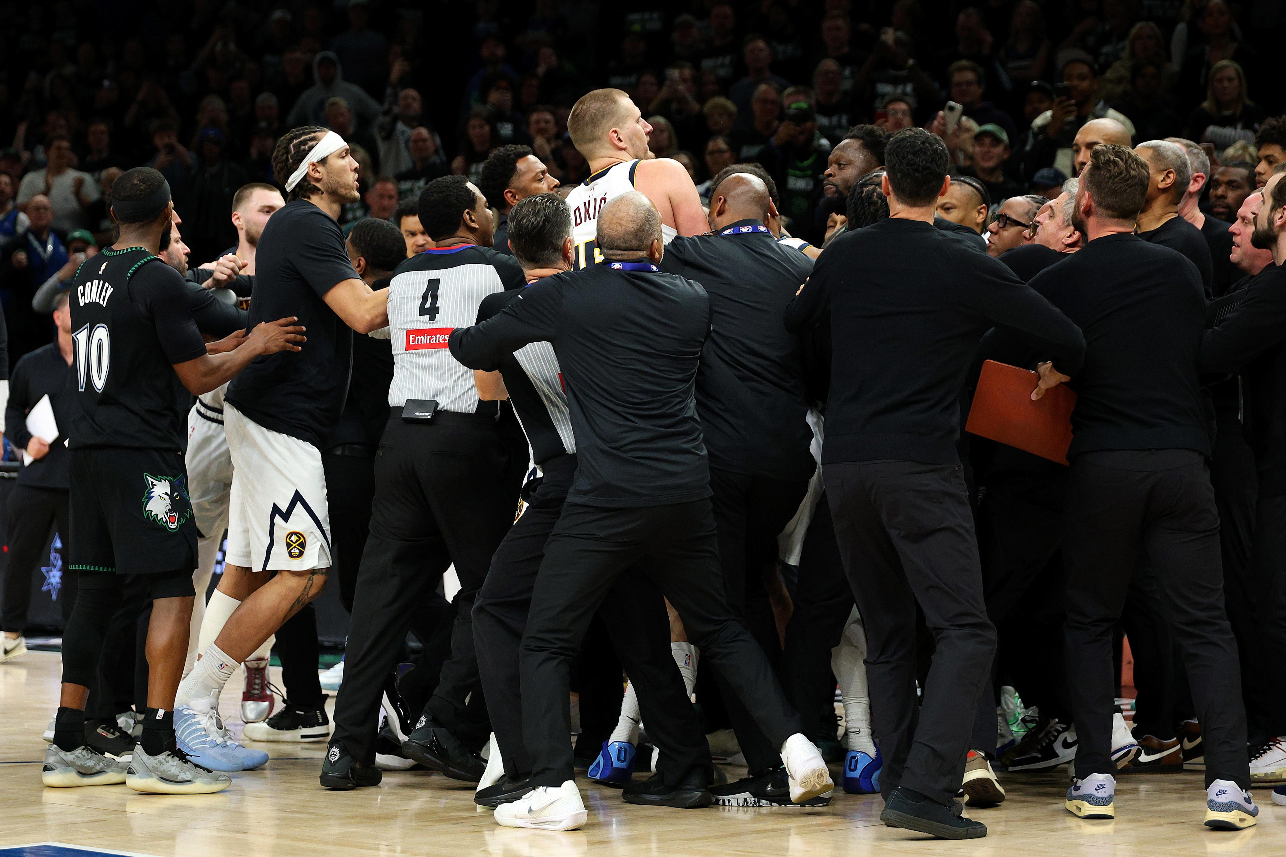 Members of the Denver Nuggets and Minnesota Timberwolves get into a scrum in the fourth quarter of Game Four of the First Round of the 2026 NBA Western Conference Playoffs at Target Center on April 25, 2026 in Minneapolis, Minnesota. Nikola Jokic #15 of the Denver Nuggets and Julius Randle #30 of the Minnesota Timberwolves were ejected from the game. The Timberwolves defeated the Nuggets, 112-96.