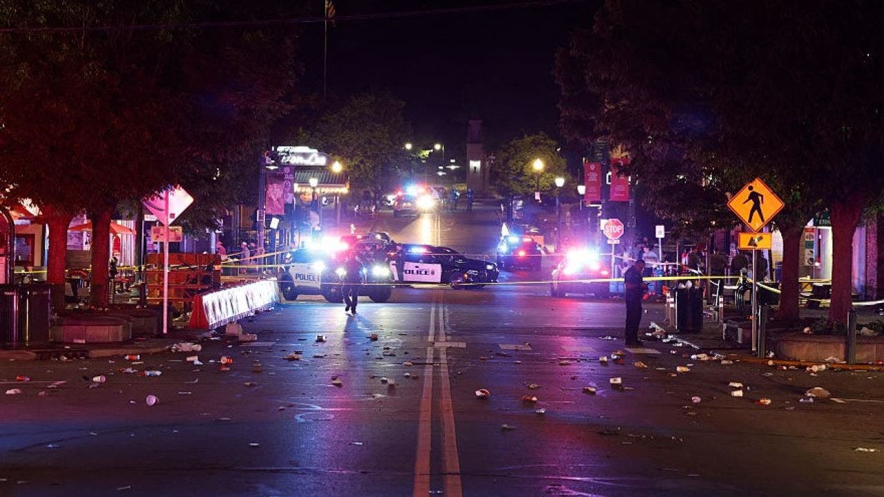 Police officers investigate the scene following a shooting on Kirkwood Avenue on April 26, 2026, in Bloomington, Indiana. According to reports, at least nine people were injured in a shooting along Kirkwood Avenue early Sunday morning.