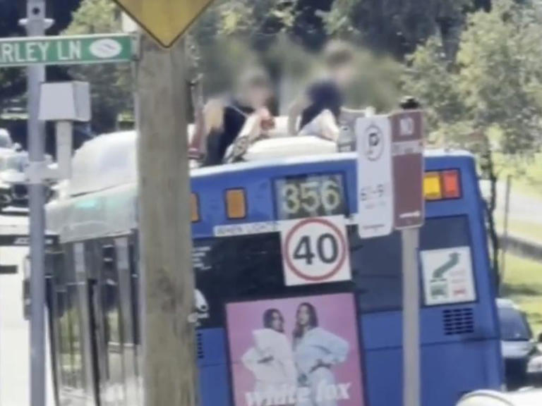 Wild moment teens spotted on bus roof