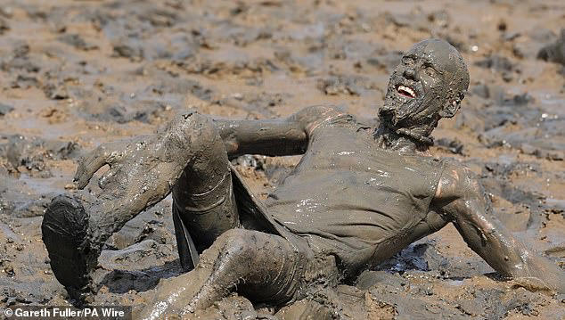 A man becomes completely drenched in mud after he seemingly slipped in the drained river bed&nbsp;