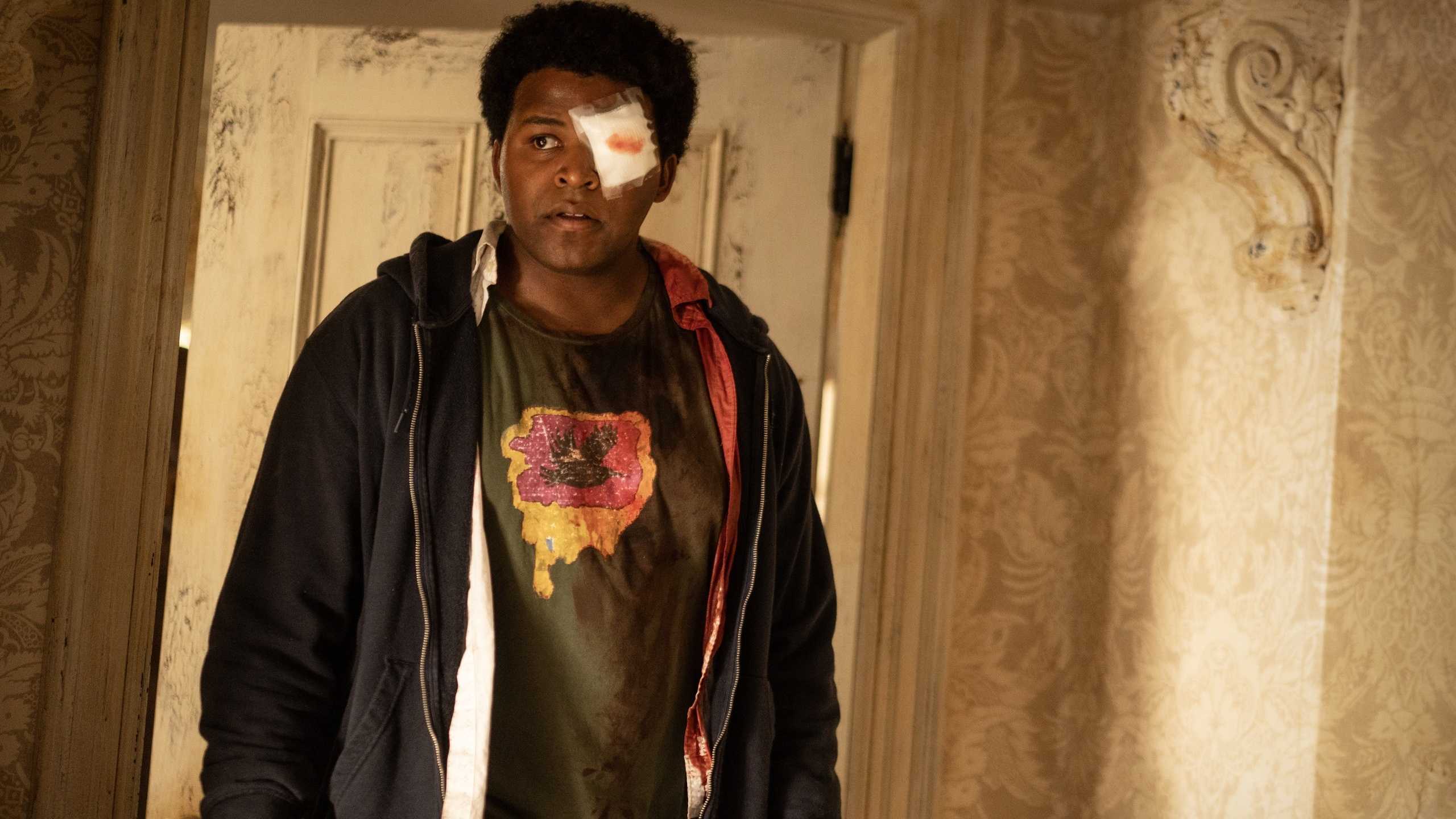 Nathan D. Simmons as Elgin Williams walking around Colony House with bloodied gauze over his eye in From season 4, episode 2