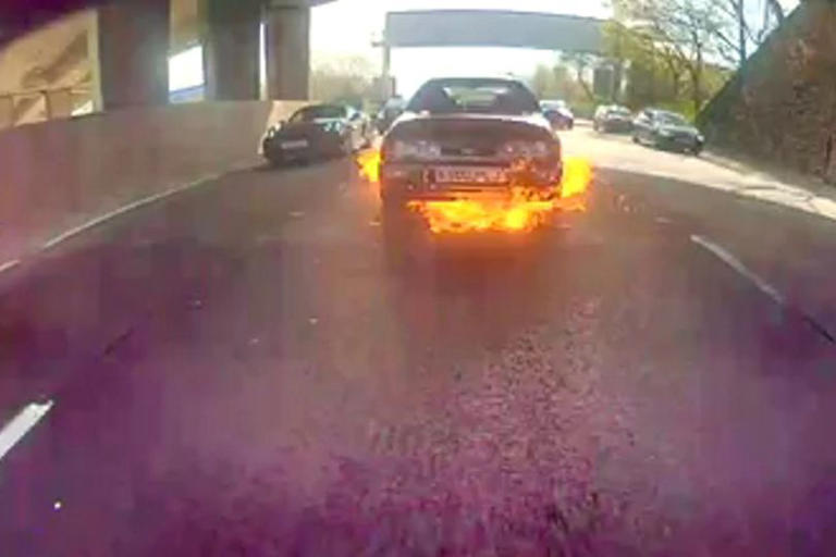 Moment car bursts into flames on Glasgow M8 as busy road grinds to a halt