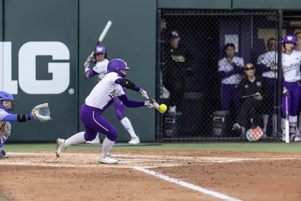 Washington Huskies outfielder Ava Carroll lays down a bunt against the UCLA Bruins. Mandatory Credit: Red Box Pictures/University of Washington Athletics