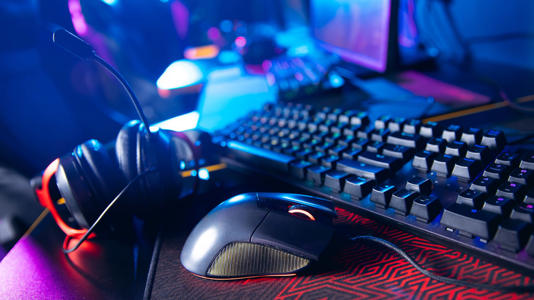 A mechanical keyboard alongside gaming equipment