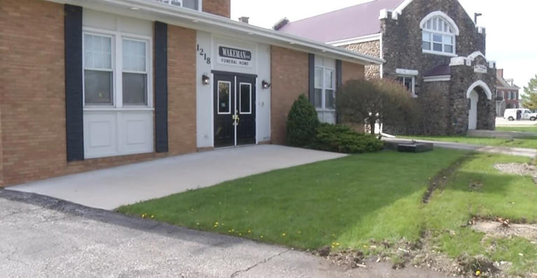 Car crashes through Wakeman Funeral Home sign