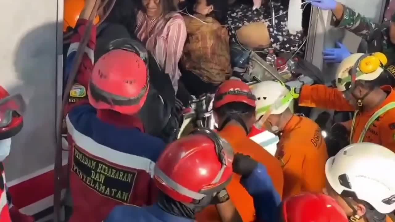 Rescue teams remove trapped passengers from train collision in Indonesia