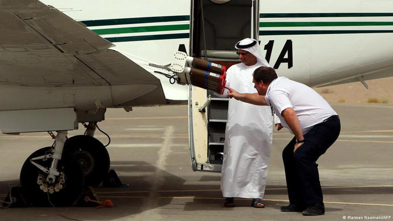 A pilot and UAE official check salt flares on a cloud-seeding aircraft at Al-Ain airport in 2015. The UAE runs nearly 300 cloud seeding missions a year to address water scarcity