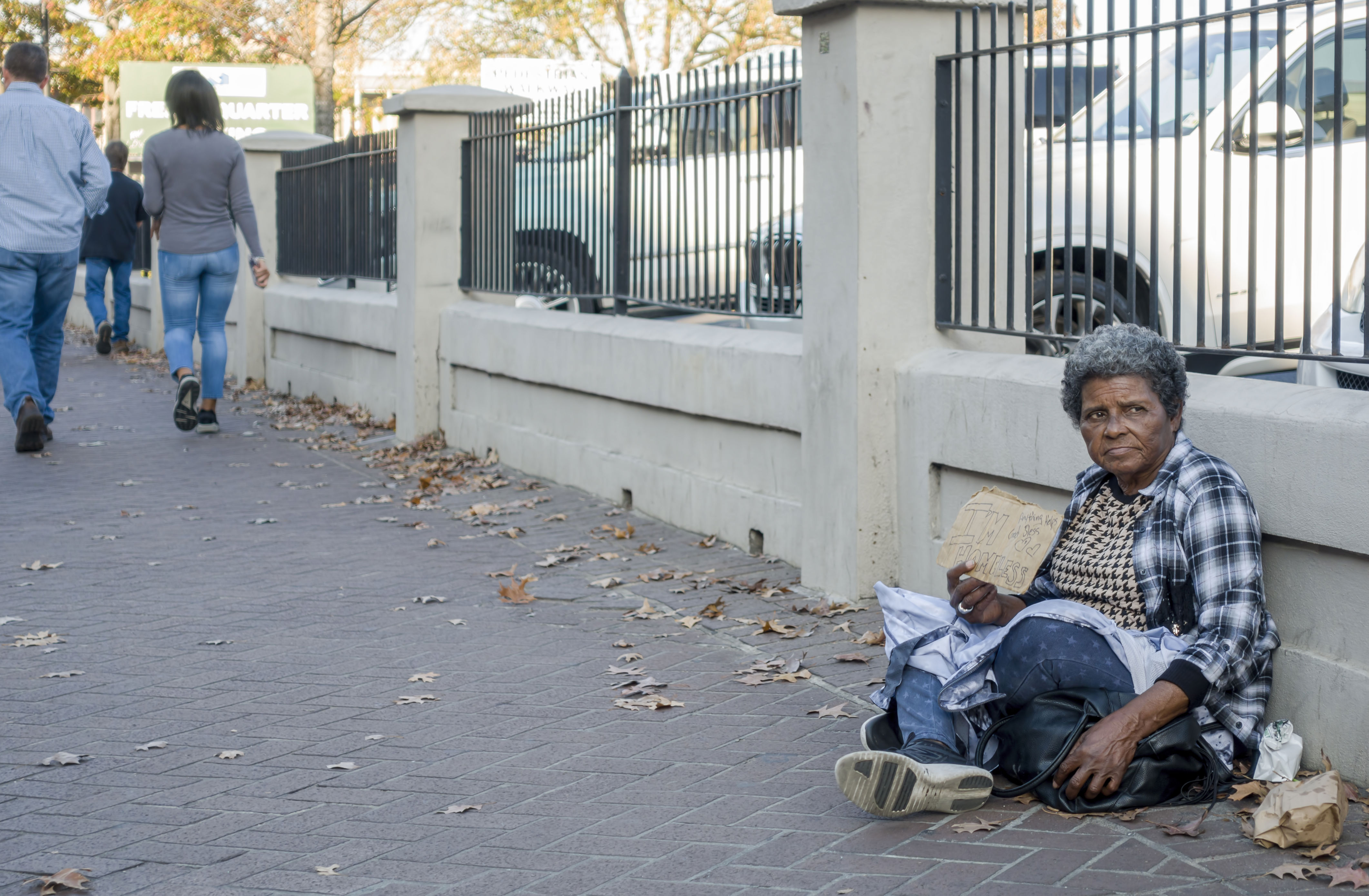Homeless lady sitting on the sidewalk along Decatur Street