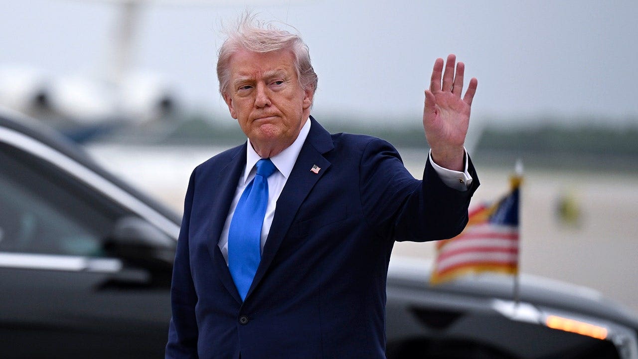 U.S. President Donald Trump waves after landing at Joint Base Andrews as he returns to Washington on April 25, 2026, in Joint Base Andrews, Maryland.
