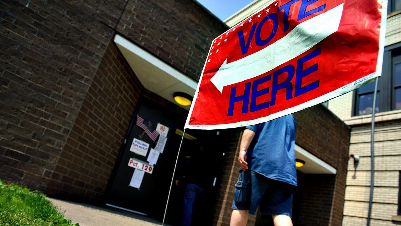 Voters head into the polls outside the Tridelphia Middle School polling place in Wheeling, W.Va., on May 8, 2018, during the West Virginia spring primaries.