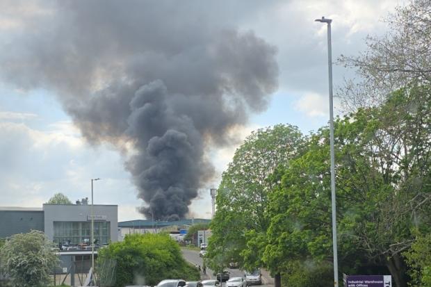 Firefighters battle to stop spread of major fire at factory