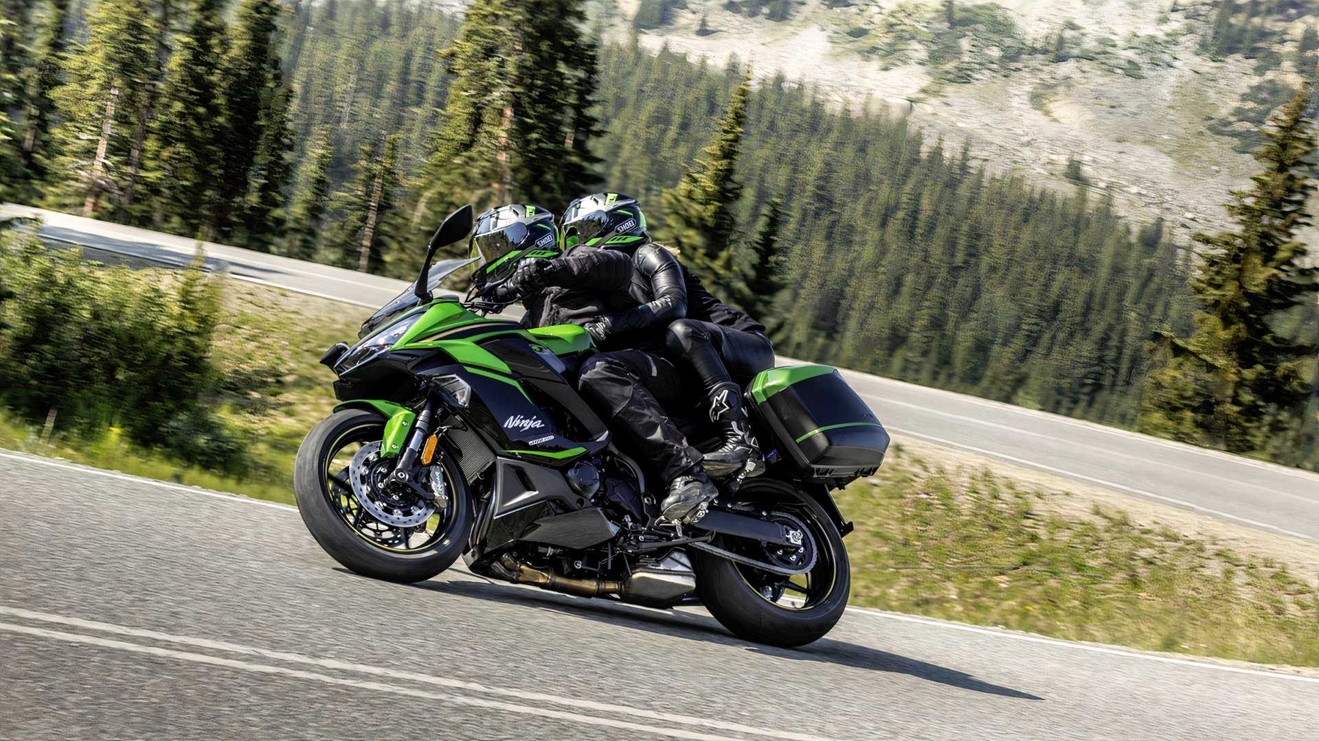 A rider with a pillion cornering on the Kawasaki Ninja 1100SX