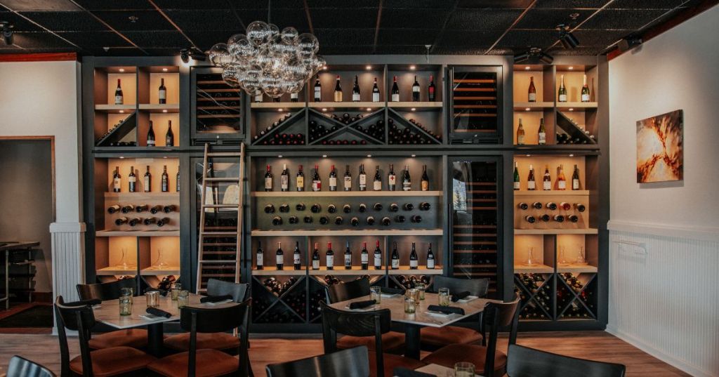 Bistro North's dining room, featuring a wine cellar wall and chic bubble chandelier in Dillon, Colorado.