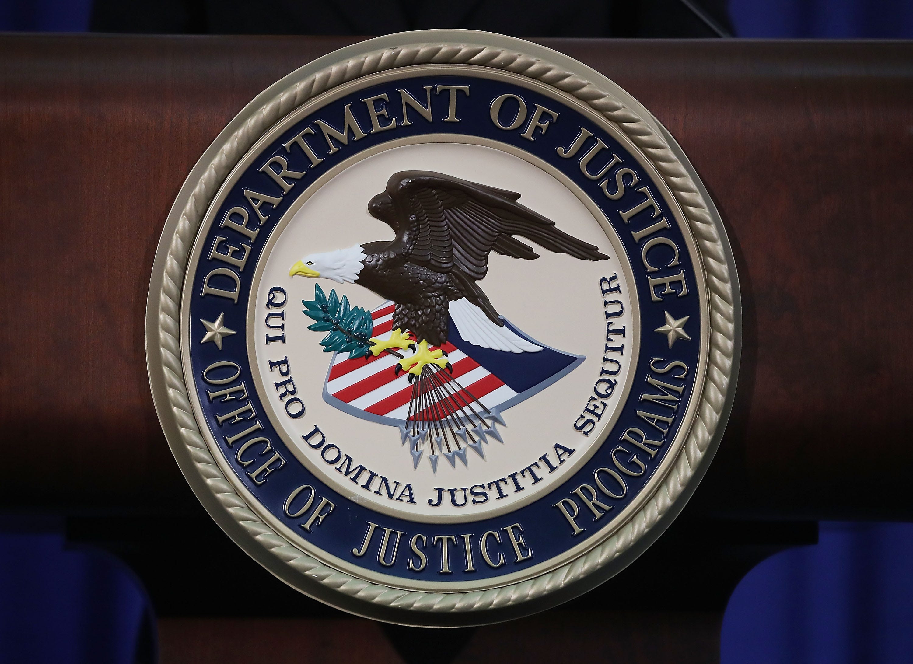 The Justice Department seal is seen on the lectern during a Hate Crimes Subcommittee summit on June 29, 2017 in Washington, DC. The meeting gave stakeholders the opportunity to offer input to the committee before it makes its recommendations to the attorney general on what the Department of Justice can do to improve reporting, investigation and prosecution of hate crimes.
