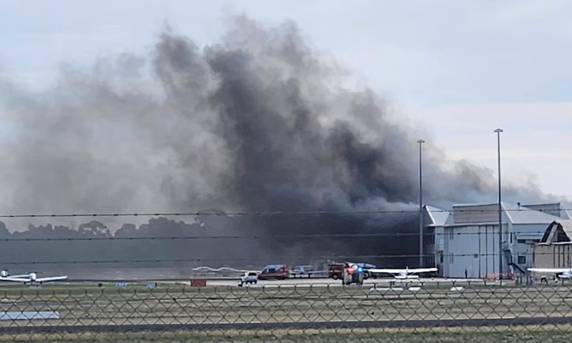 Two dead and 11 injured after plane crashes into airport hanger