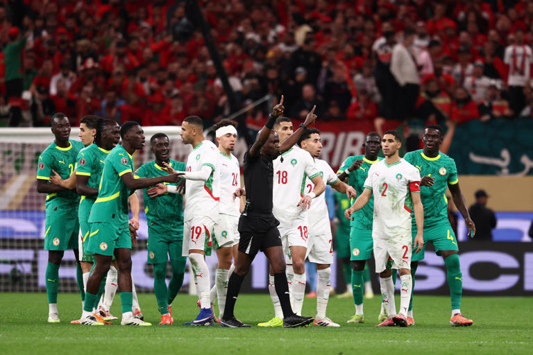 Congolese referee Jean-Jacques Ndala Ngambo calls for a VAR decision during the Africa Cup of Nations final football match between Senegal and Morocco.