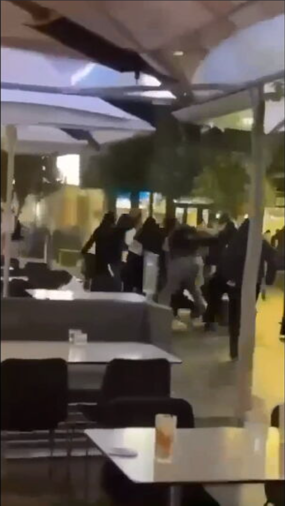 Patrons at a Melbourne restaurant ran away in panic after a masked group attacked a gathering with machetes last night, leaving a teenager in hospital.
