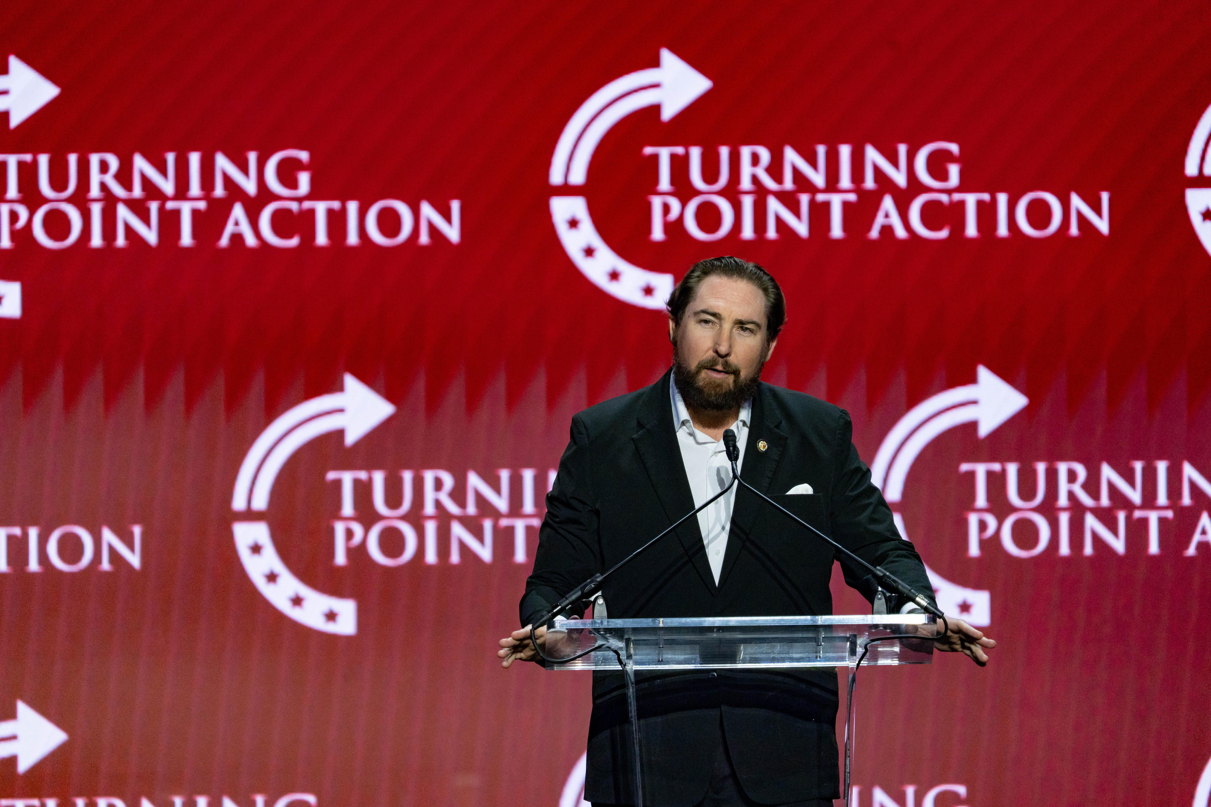 U.S. Rep. Eli Crane speaks at the Build the Red Wall rally at Dream City Church in Phoenix on April 17, 2026.
