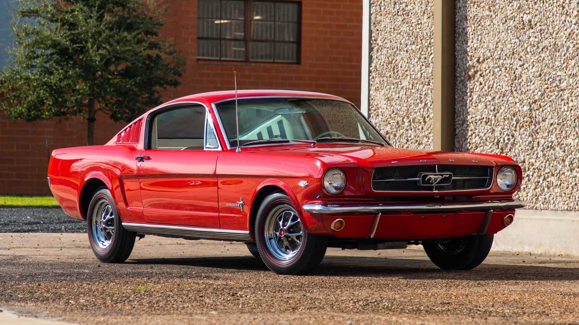 Front 3/4 view of a red 1965 Ford Mustang K-Code Fastback parked