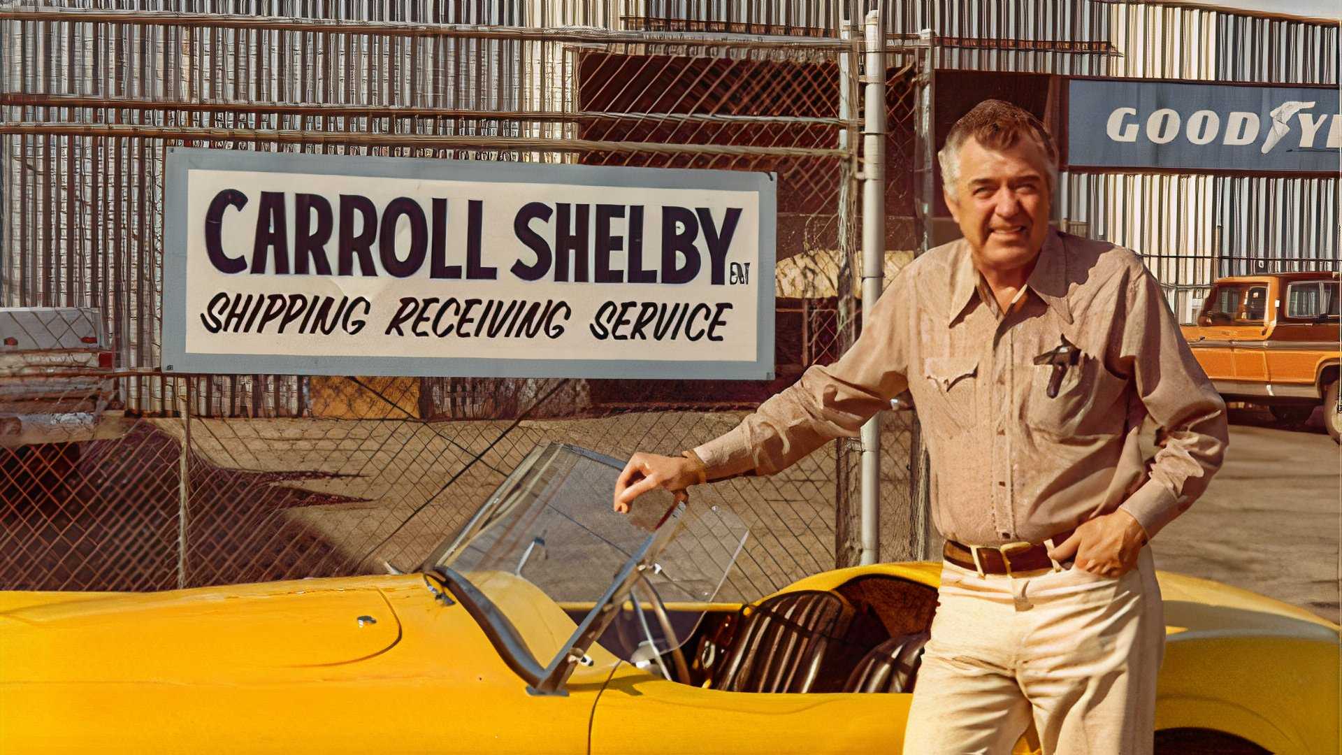 Image Of a retired Carroll Shelby sitting next to a yellow Shelby Cobra