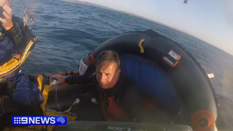 Two men have survived 24 hours floating at sea after strong currents pulled them kilometres from their dive boat off Queensland.