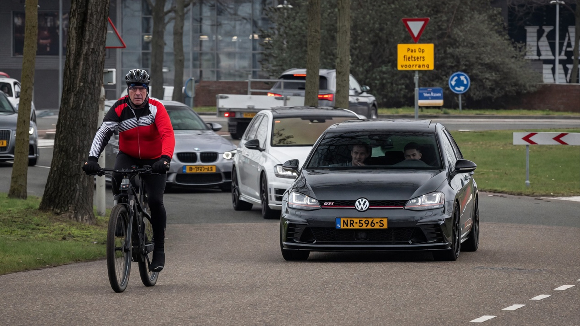 VW Golf GTI risky moment with bicycle on public road