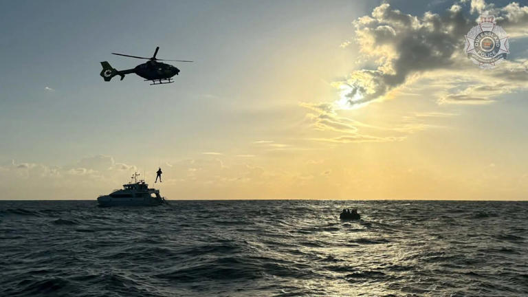 A rescue chopper crew in action where the divers were spotted. (Supplied: Queensland Police)