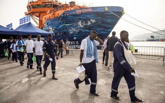 Migrants disembark from a ship docked in Salermo, Italy, after being rescued from the Mediterranean - Getty