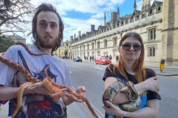 Couple take their pet snakes for a walk in Oxford city centre