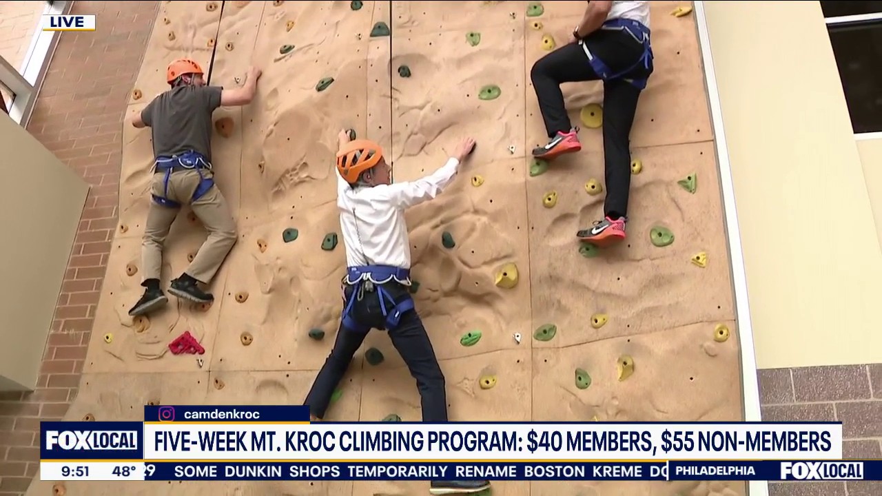 Bob attempts rock climbing wall