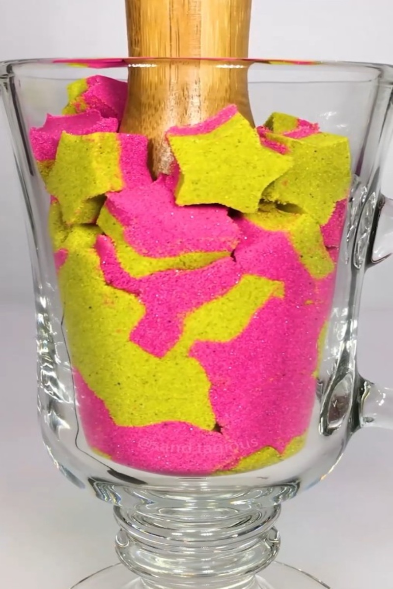 Kinetic sand star shapes pressed in glass cup