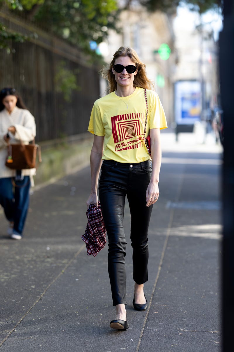 paris, france march 09: constance jablonski wears black leather ballerinas, black sunglasses, black leather skinny trousers, a red leather crossbody bag, a red and black checked shirt and a a yellow printed t shirt outside zadigvoltaire show during day eight of paris fashion week womenswear fall/winter 2026/2027 on march 09, 2026 in paris, france. (photo by valentina frugiuele/getty images)